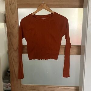 Size large orange crop top, long sleeved.